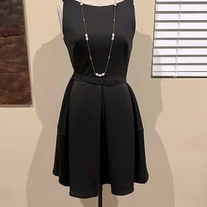 Black sleeveless dress. You can dress it up are down. Very sexy.